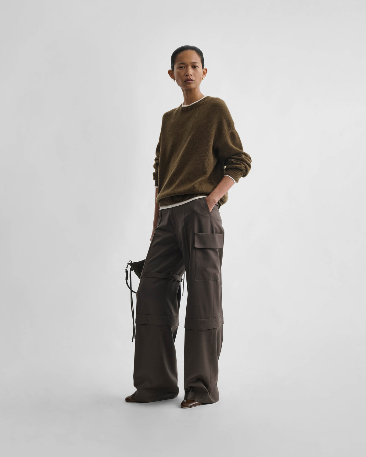 Front view of model wearing STRAP TROUSERS in brown khaki wool