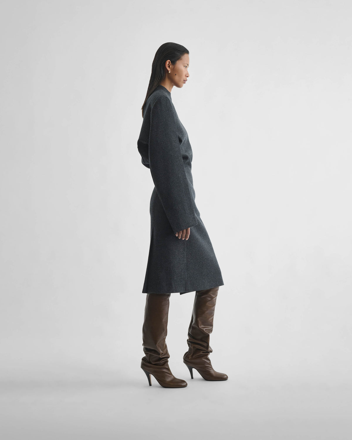Side view of model wearing KINKED TAILORED DRESS in anthracite wool cashmere