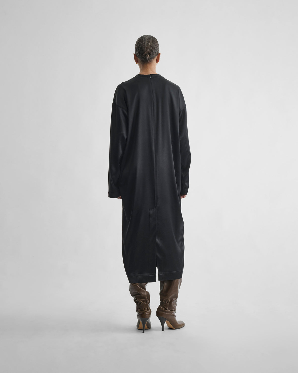 Back view of model wearing CREW NECK DRESS in black silk