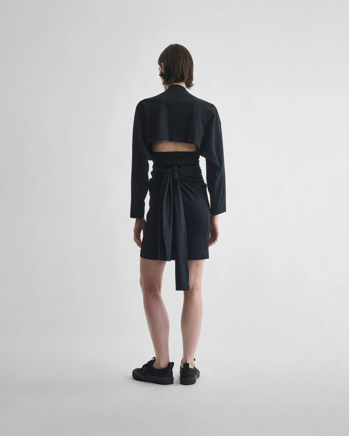 Back view of model wearing TIE T-SHIRT DRESS in black cotton