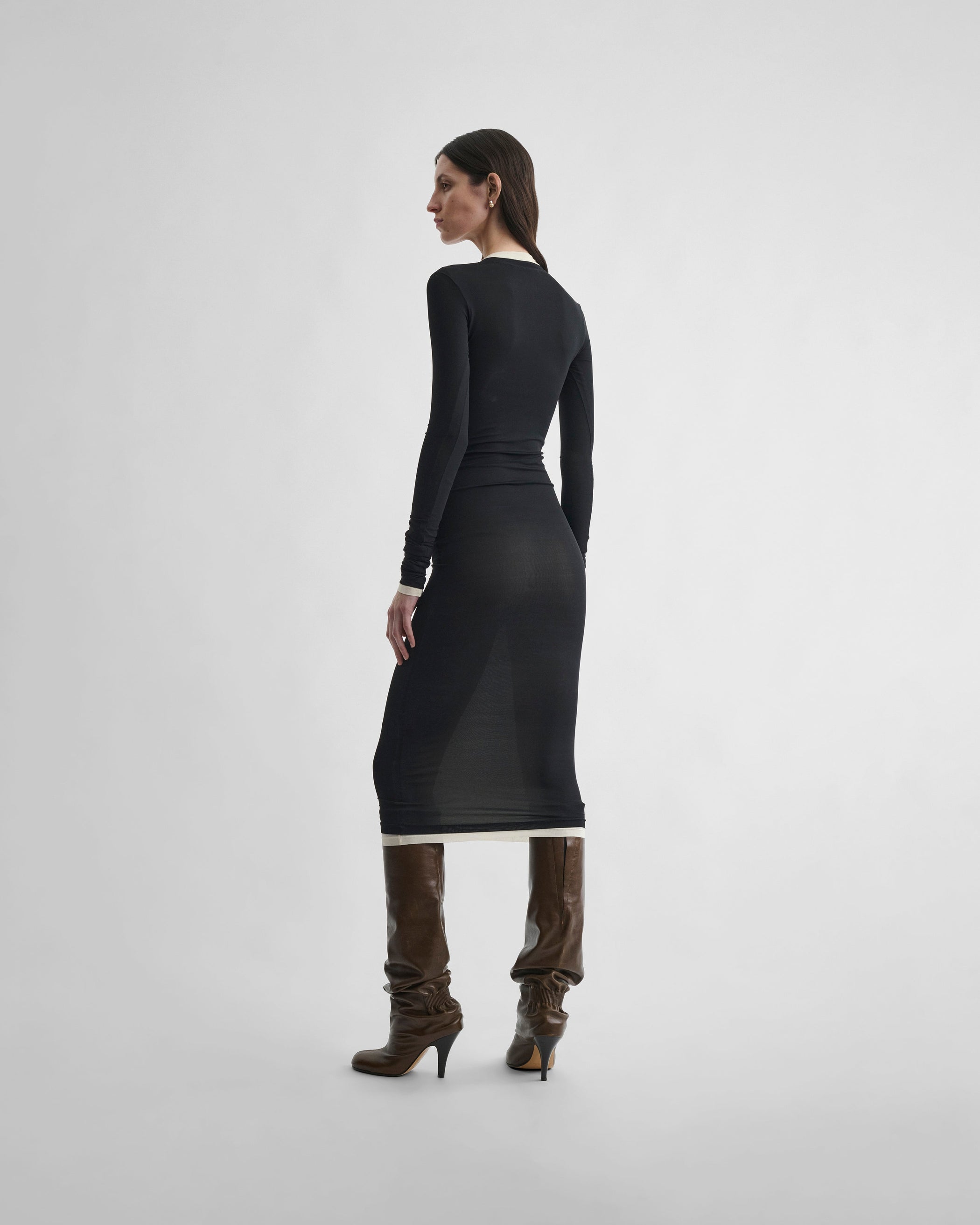 Side view of model wearing HUG DRESS in black viscose