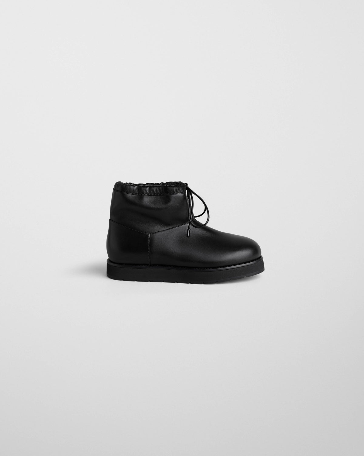 Side view of SHEARLING BOOTIE in black leather