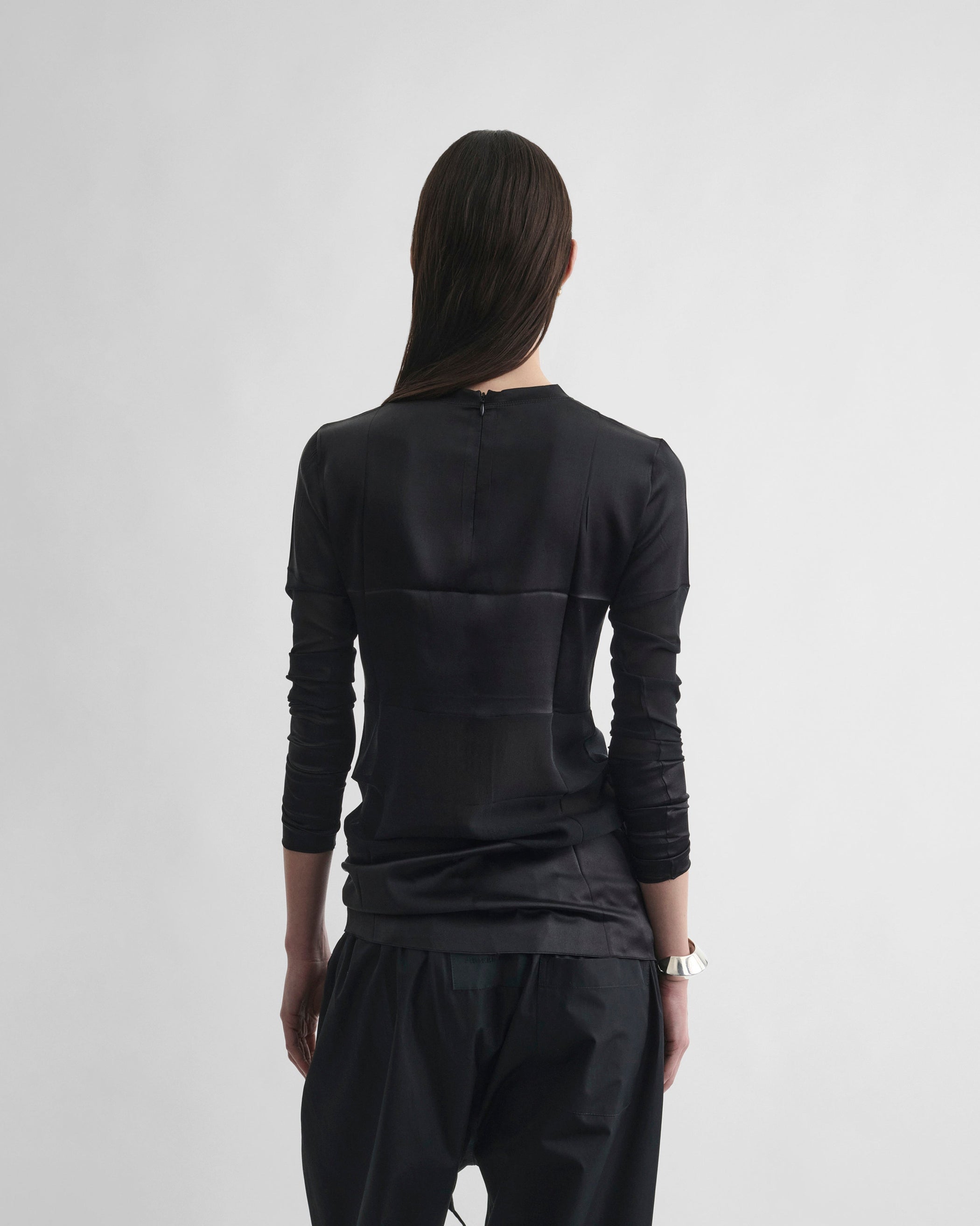 Back view of model wearing PANEL TOP in black silk