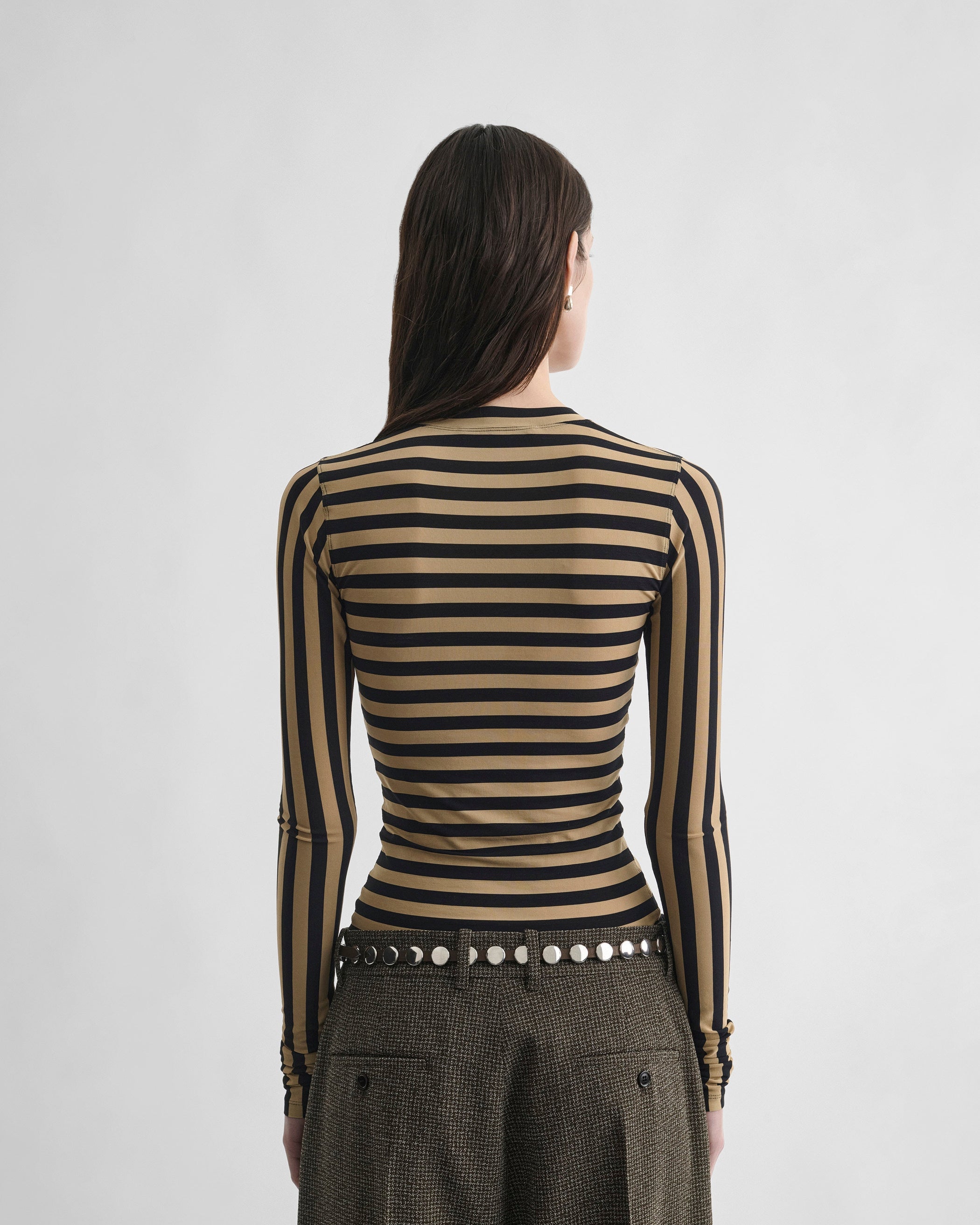 Back view of model wearing STRIPE TOP in toffee/black viscose