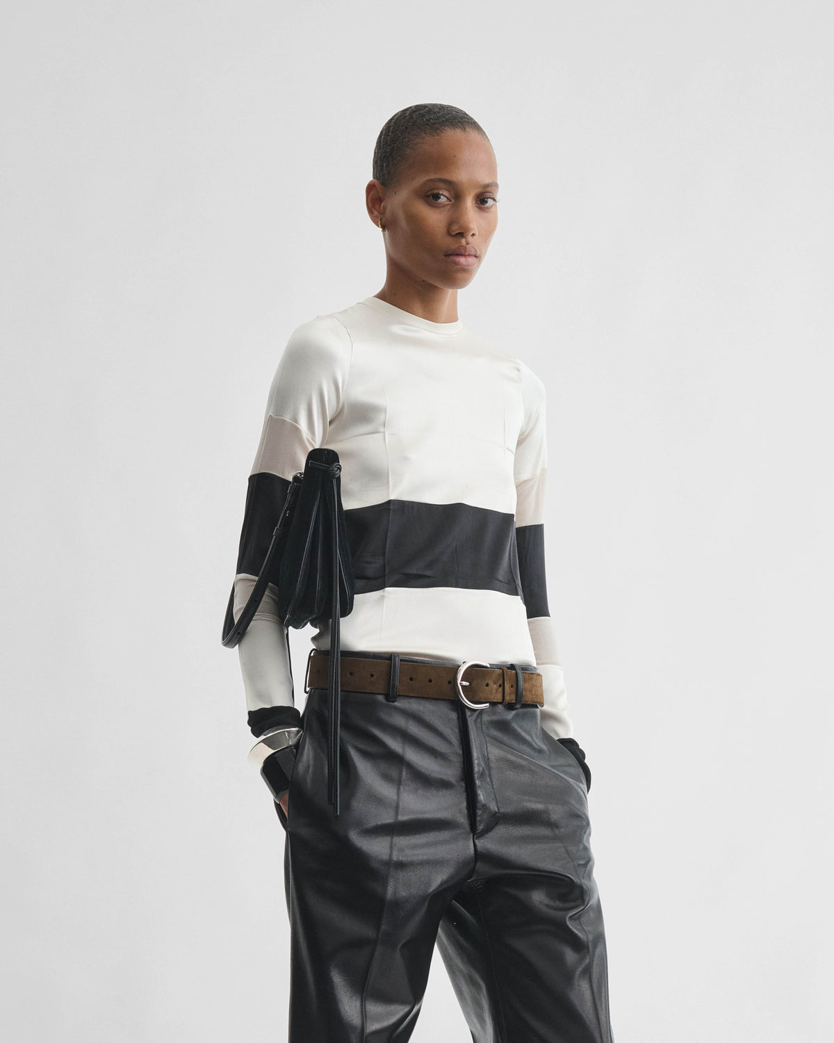 Front view of model Wearing PANEL TOP in black white silk