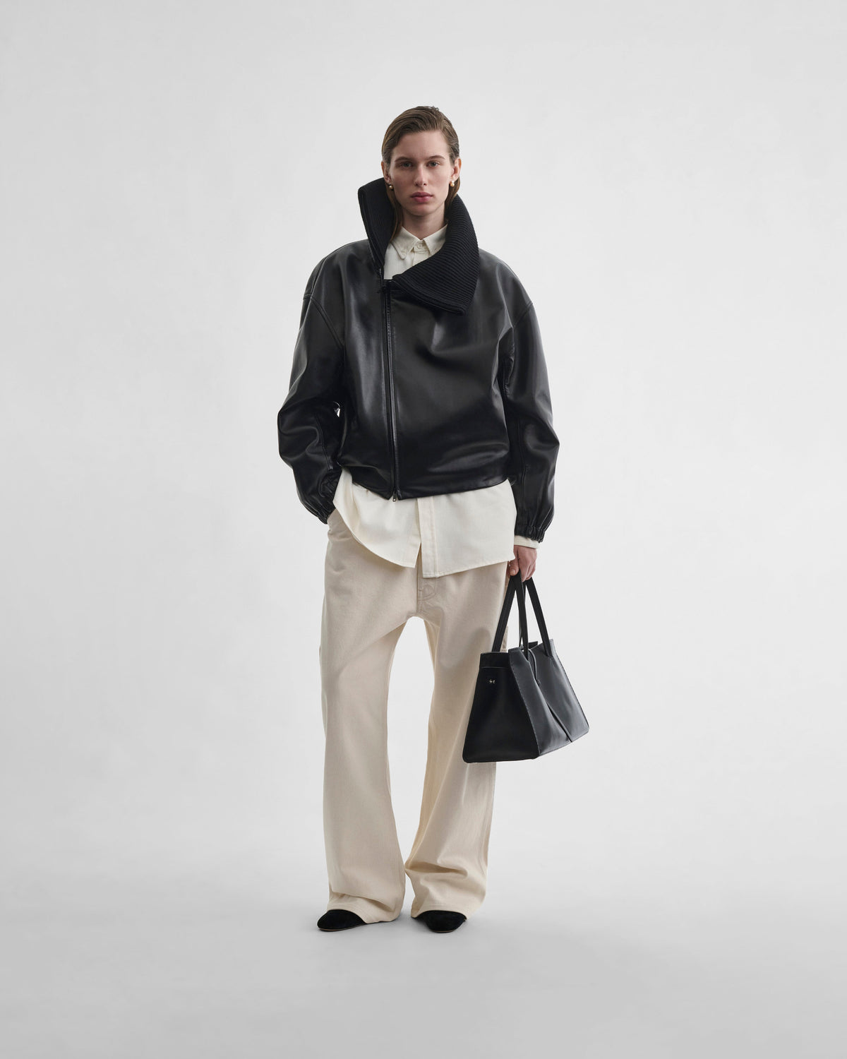 Front view of model wearing RIB NECK JACKET in black leather