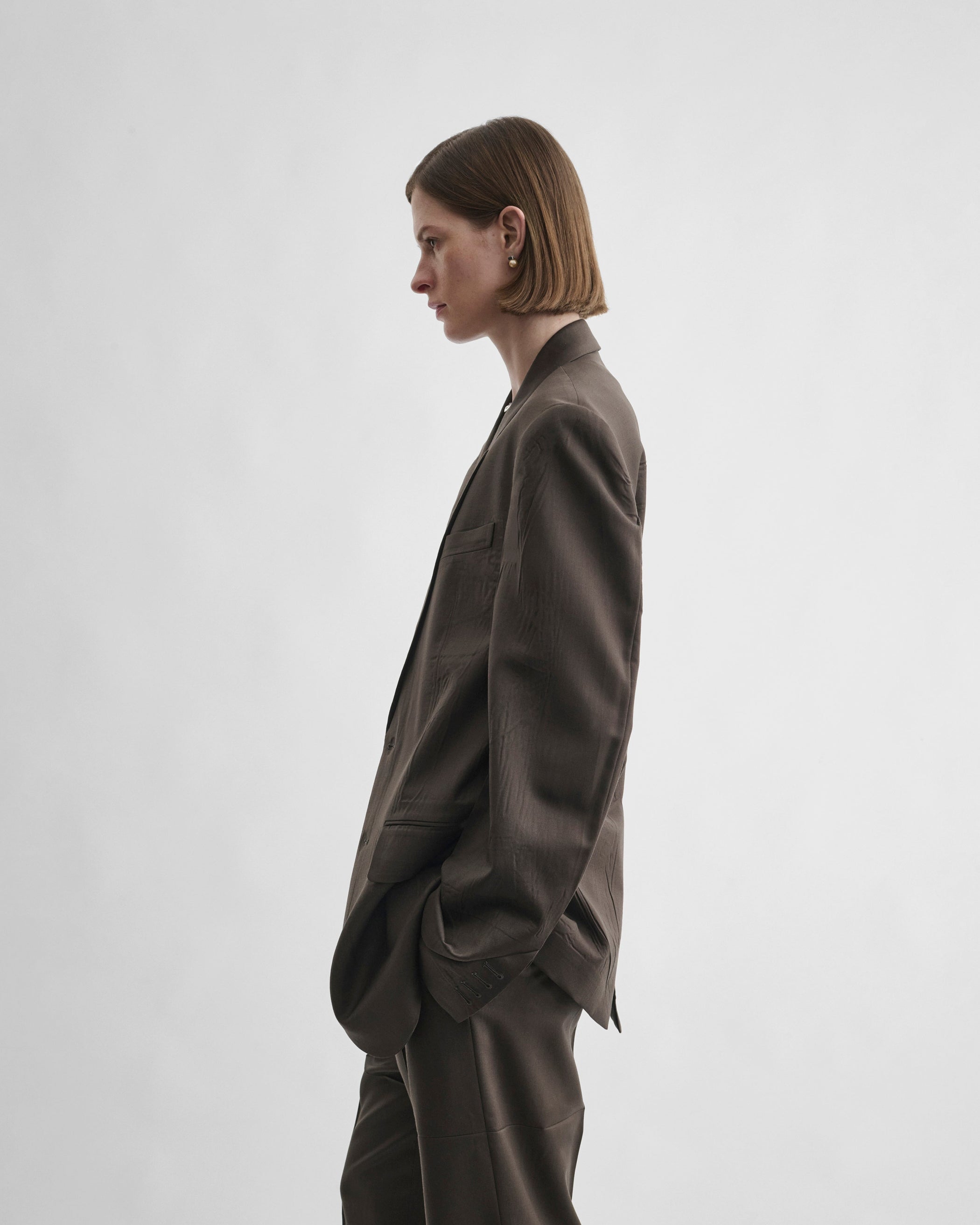 Side view of model wearing NEAPOLITAN JACKET in brown khaki wool