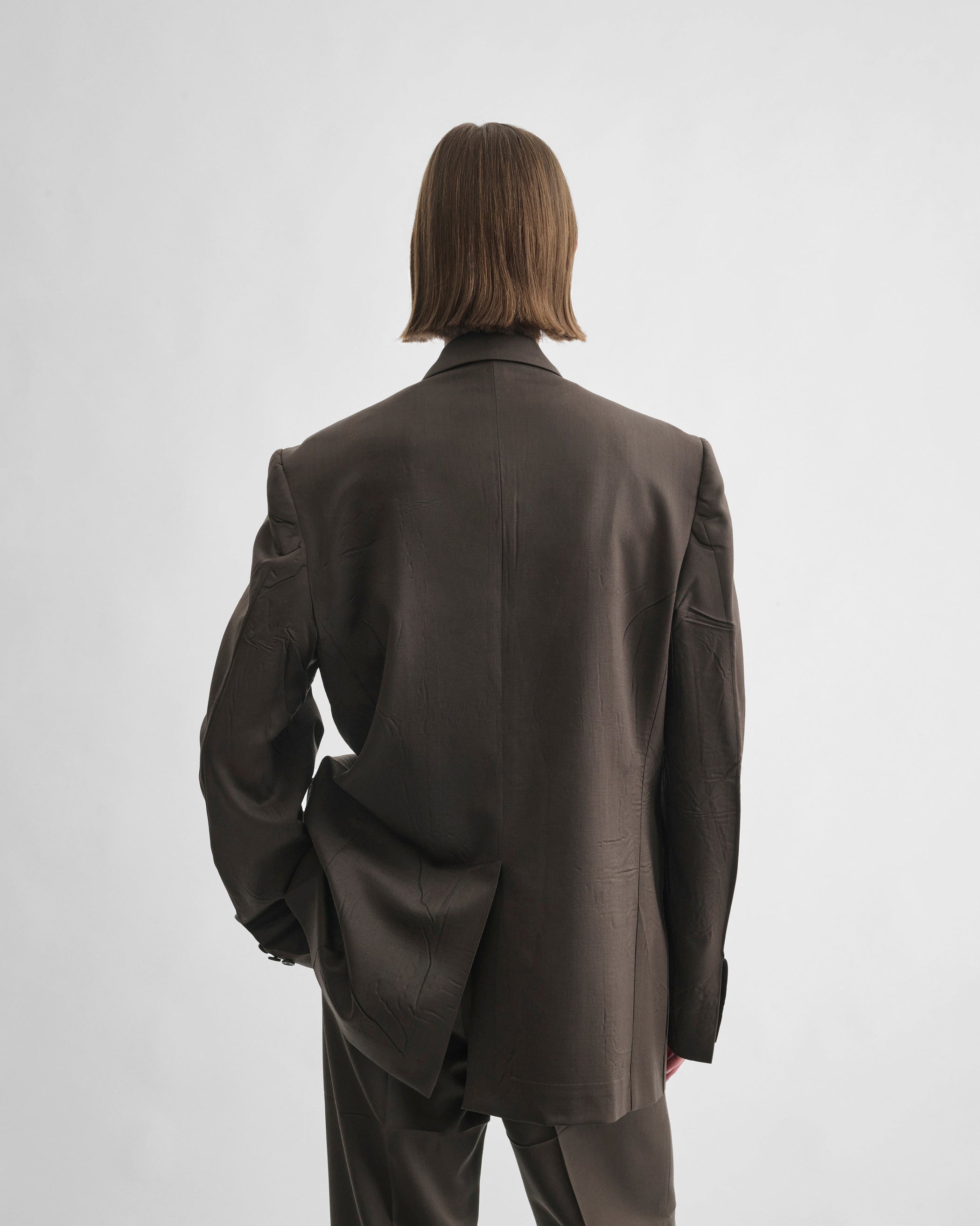Back view of model wearing NEAPOLITAN JACKET in brown khaki wool