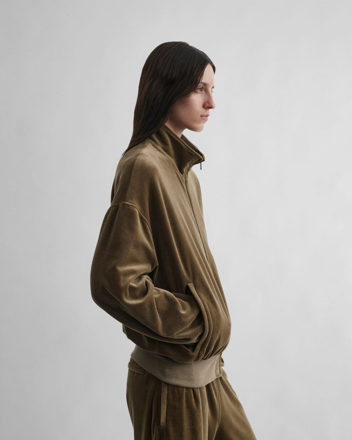 Side view of model wearing VELVETEEN BOMBER in bronze velour