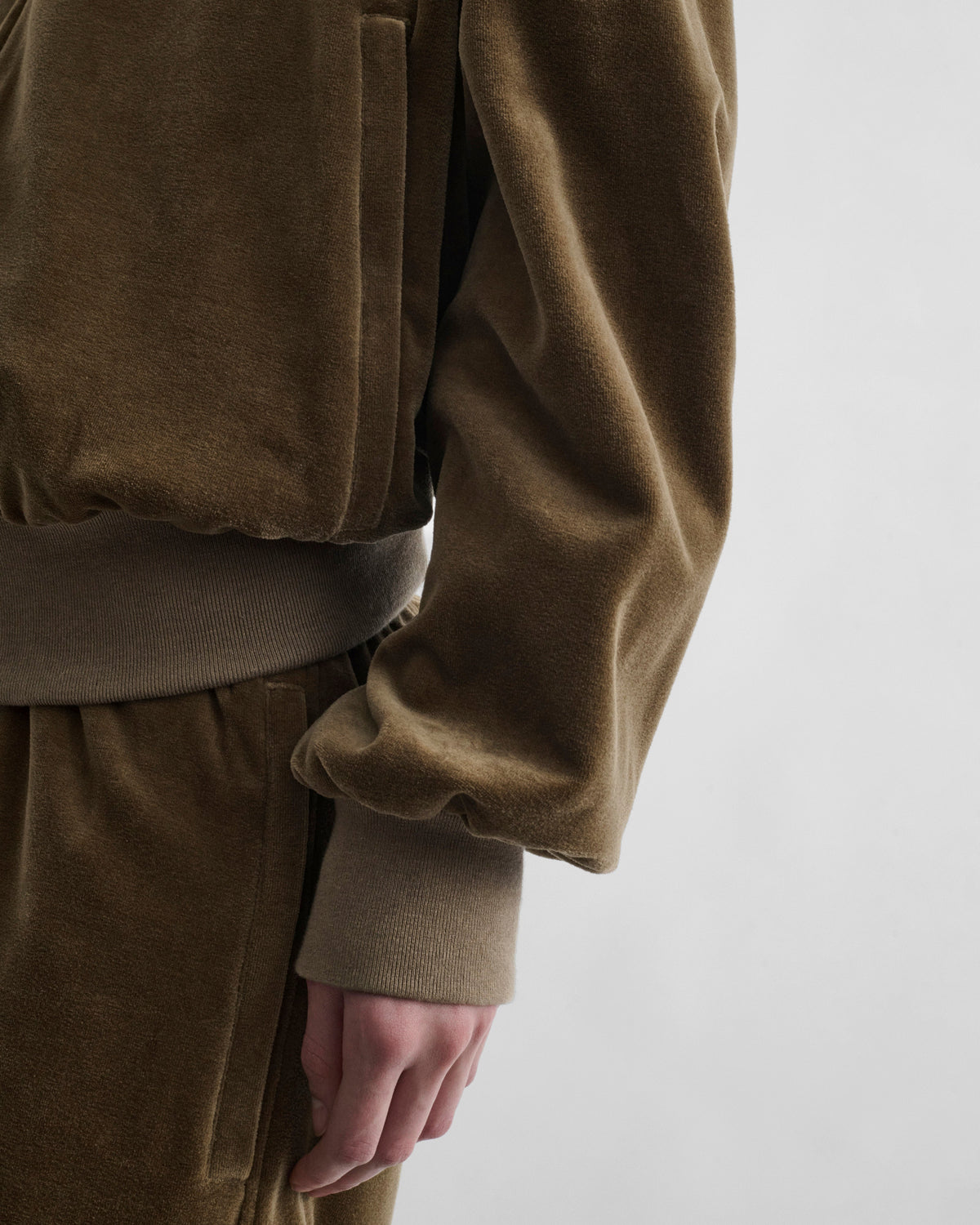 Detail view of model wearing VELVETEEN BOMBER in bronze velour
