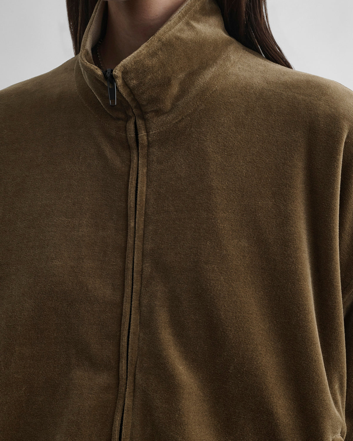 Detail front view of model wearing VELVETEEN BOMBER in bronze velour